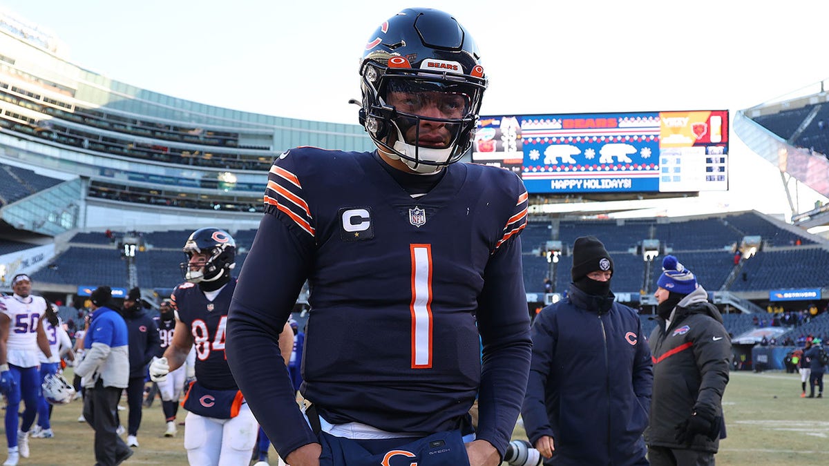 Justin Fields walks off after playing the Bills