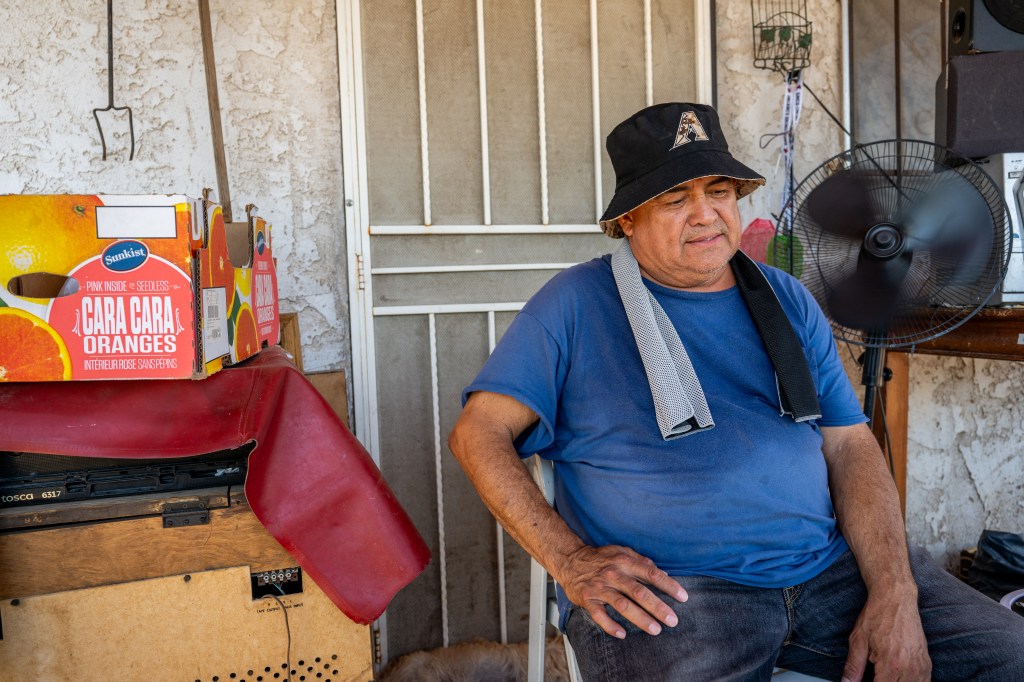 Richard Verduzco keeps cool on his porch ahead of his air conditioning unit installation during a heat wave on July 15, 2023 in Phoenix, Arizona. 