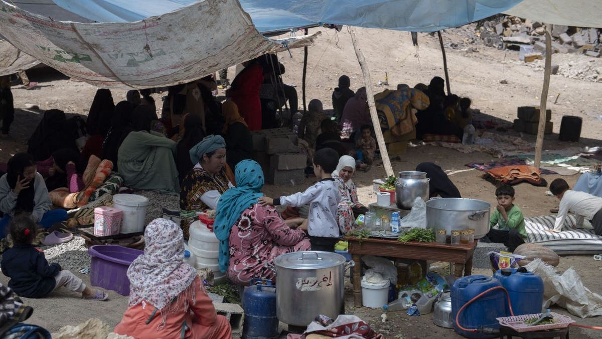 Moroccans sitting near tent