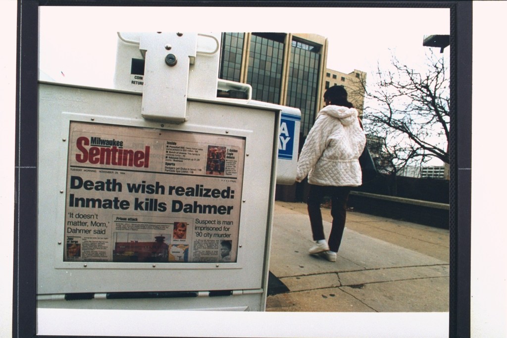 A newspaper vending machine sporting the Milwaukee Sentinel shows a copy of a newspaper headlining Jeffrey Lionel Dahmer being killed by his inmate. 