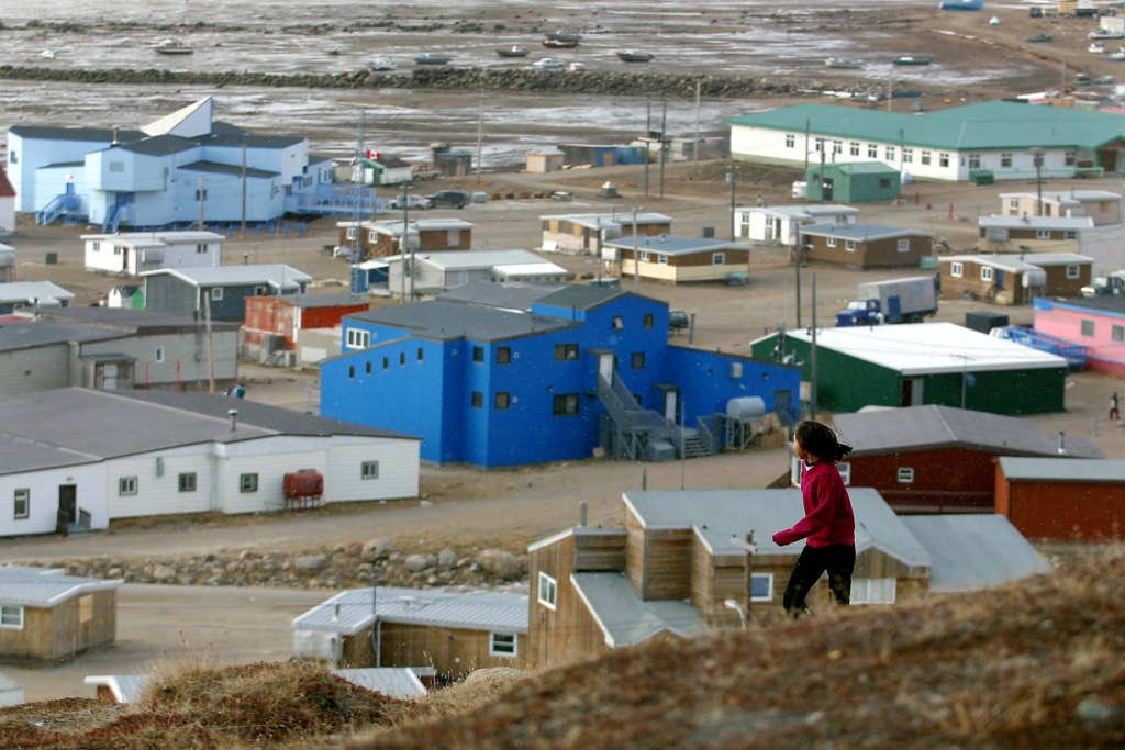  A young native girl runs on a hill overlooking the village of Iqaluit, in Nunavut.