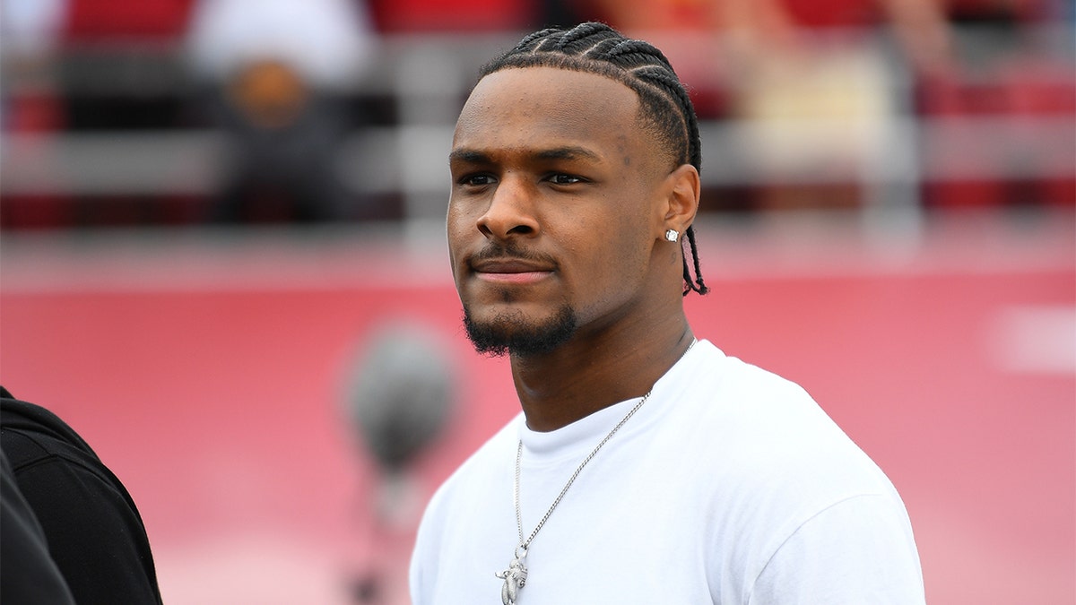 Bronny James looks on at a USC football game