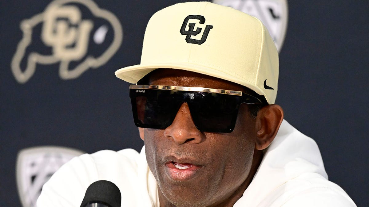 Deion Sanders speaks to reporters