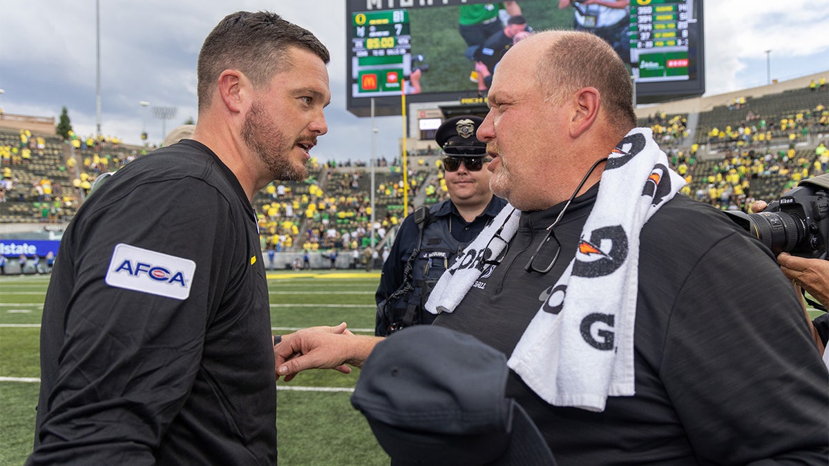 Dan Lanning and Bruce Barnum shake hands