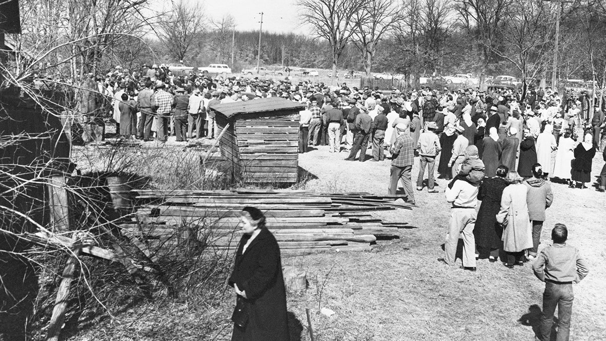 A crowd surrounding Ed Geins home