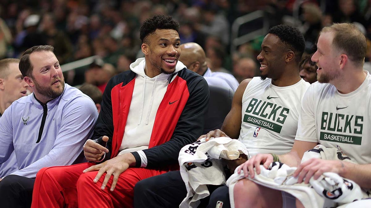 Giannis Antetokounmpo sits on the bench