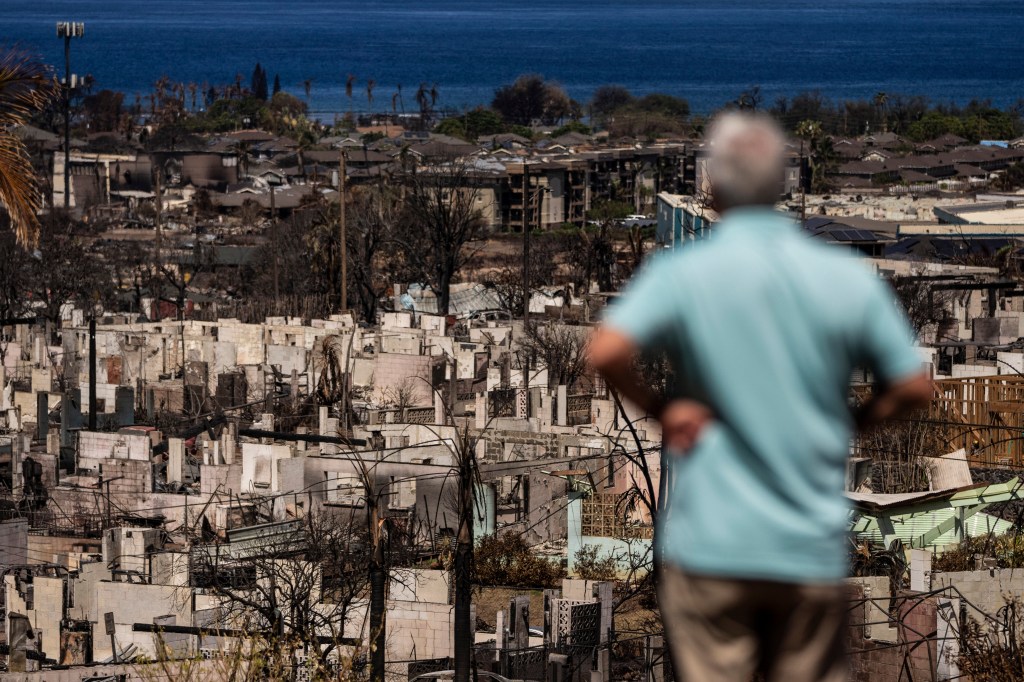 A man views the aftermath of a wildfire in Lahaina, Hawaii, on Aug. 19, 2023.