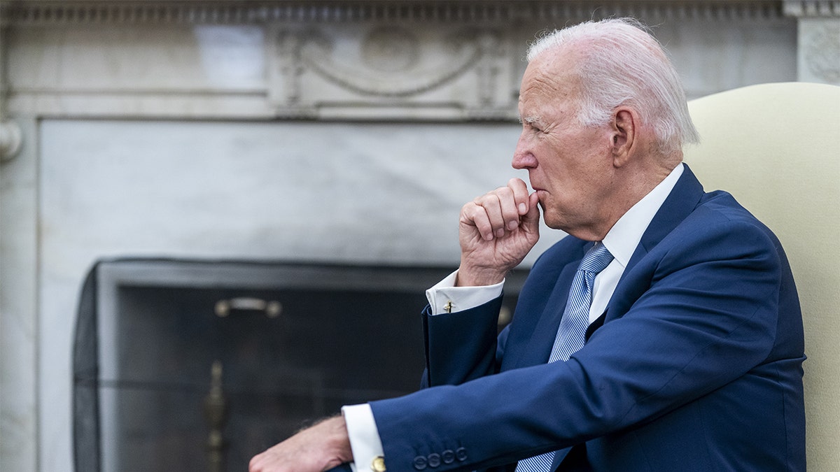 Biden sitting in the Oval Office.