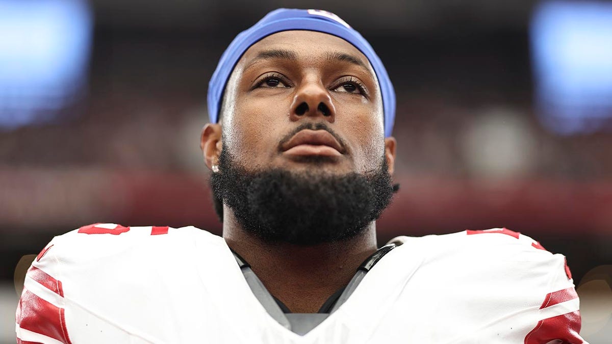 Kayvon Thibodeaux listens to the anthem