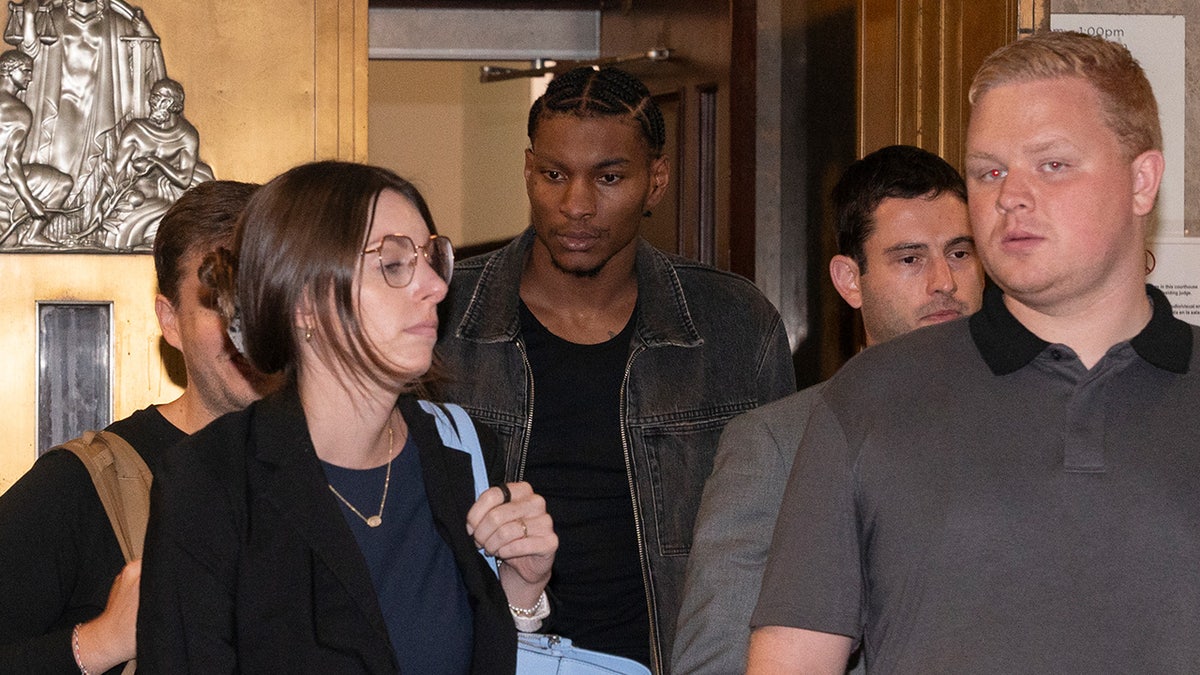 Kevin Porter Jr. shown surrounded by his legal team as he leaves court.