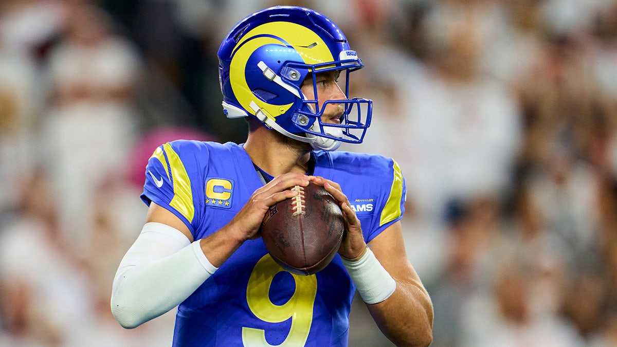 Rams QB Matthew Stafford holding a football