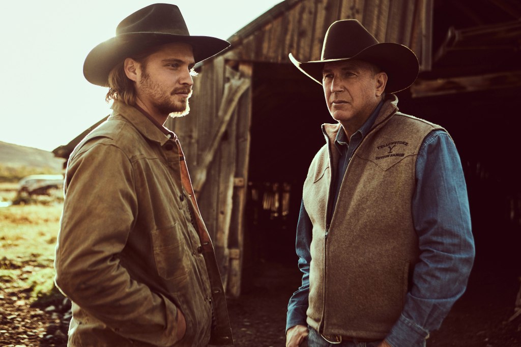 Kayce Dutton (Luke Grimes) and dad John Dutton (Kevin Costner) in "Yellowstone" standing together. 