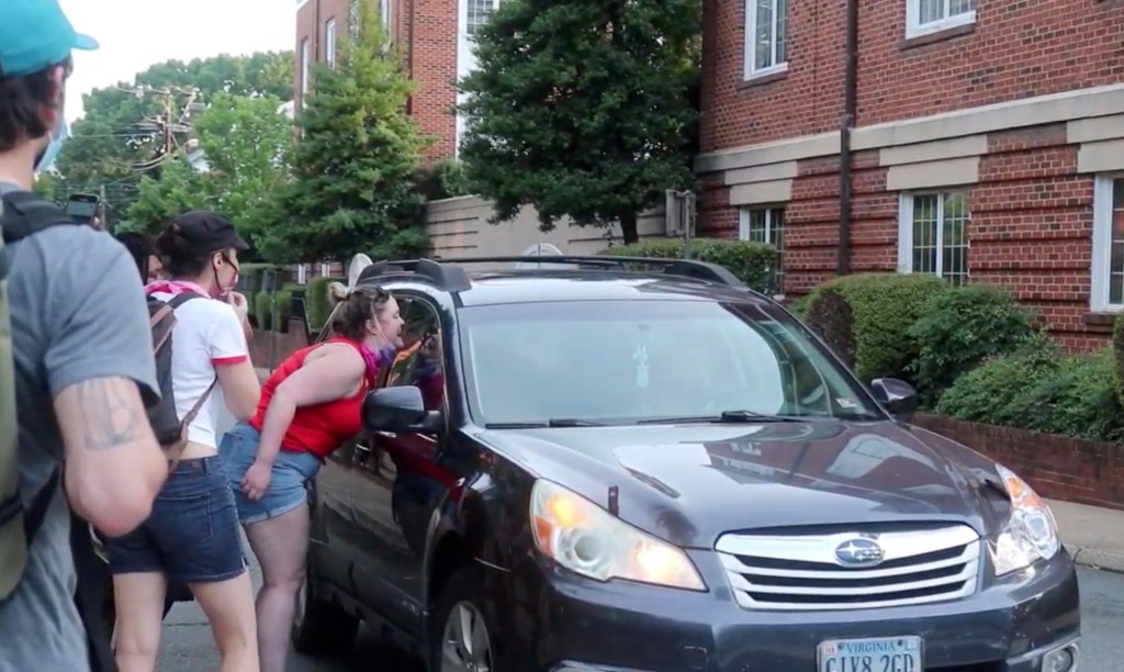 Black Lives Matter protesters are seen confronting Bettinger, who remained inside her vehicle.