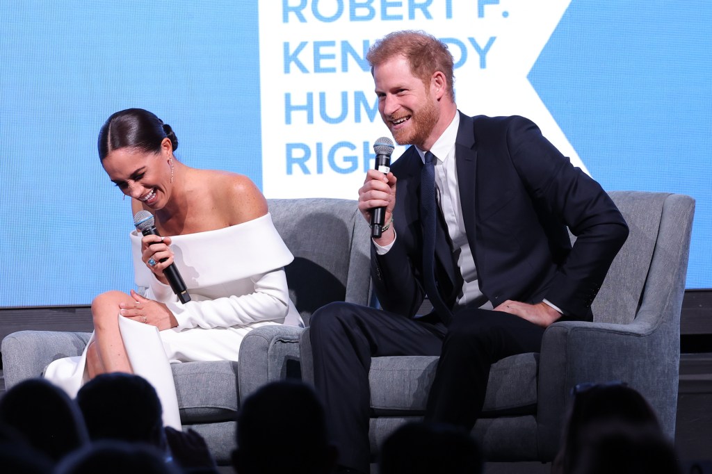 Photo of Prince harry and Meghan Markle laughing. 