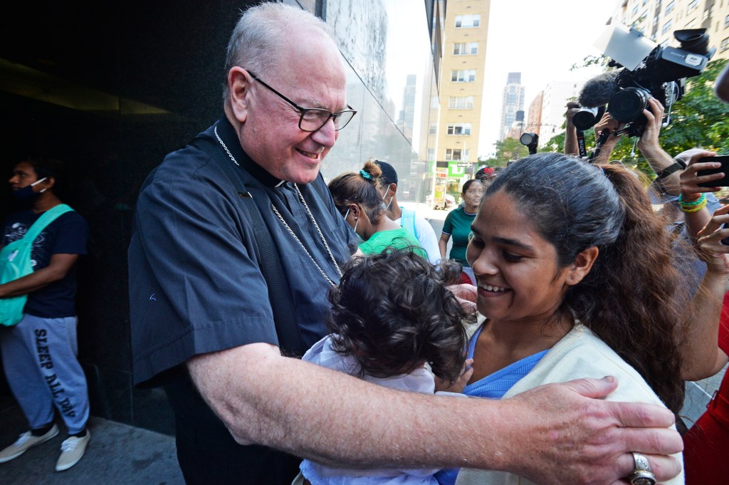 Cardinal Timothy Dolan greets newly arrived migrants at the New York Catholic Center, 1011 1st Ave.