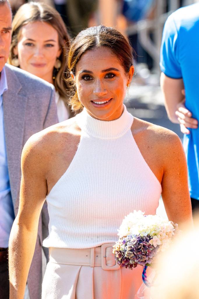 Photo of Meghan Markle in a white turtleneck tank top. 