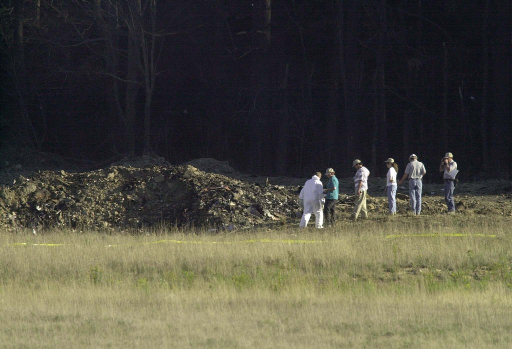 Officials examine the crater in Shanksville, Pa., created by the crash of Flight 93.