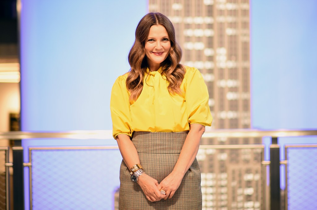 Photo of Drew Barrymore in a yellow shirt. 