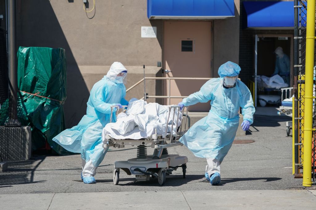 In this file photo bodies are moved to a refrigeration truck serving as a temporary morgue at Wyckoff Hospital in the Borough of Brooklyn on April 6, 2020 in New York