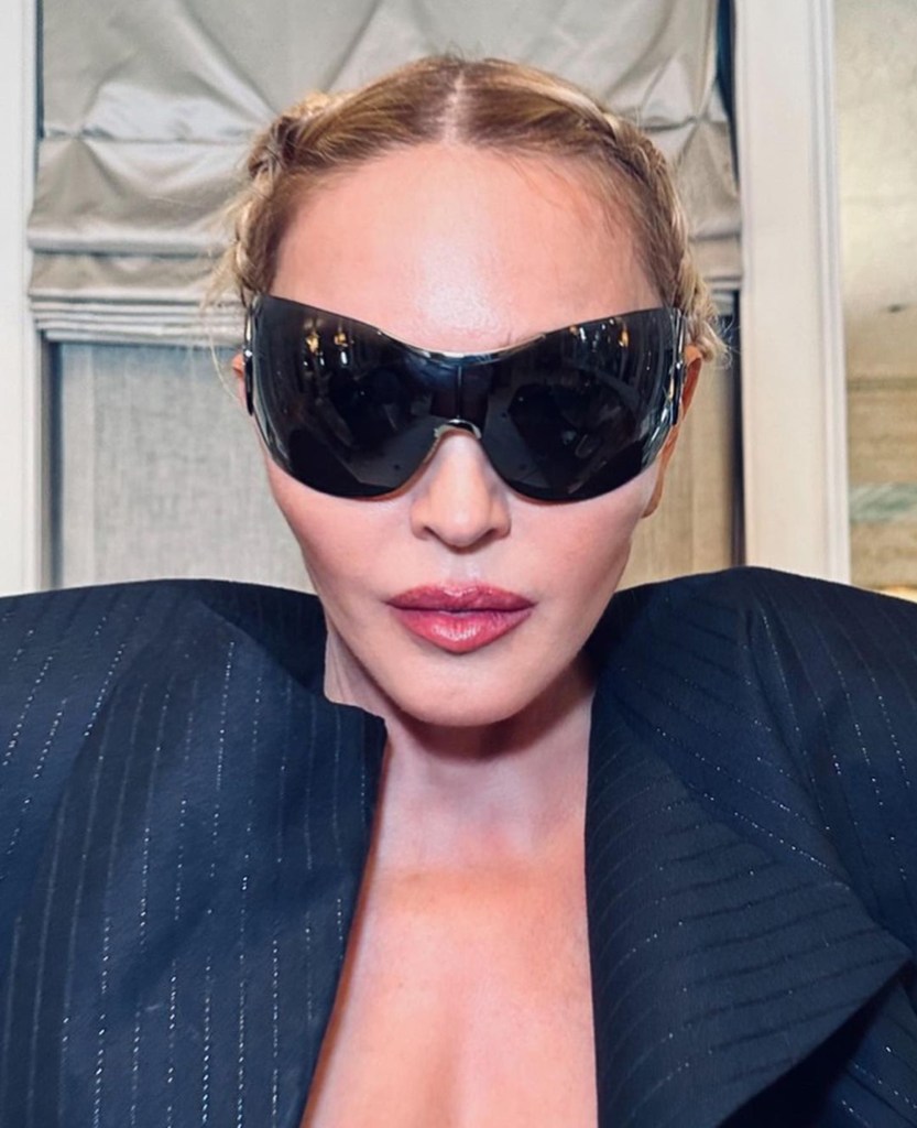 Photo of Madonna in a pair of bug-like glasses. 