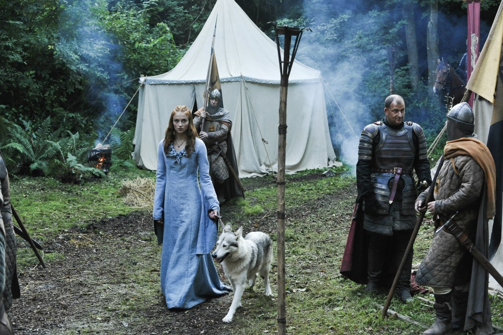 Sansa Stark  by  tent with a wolf. 