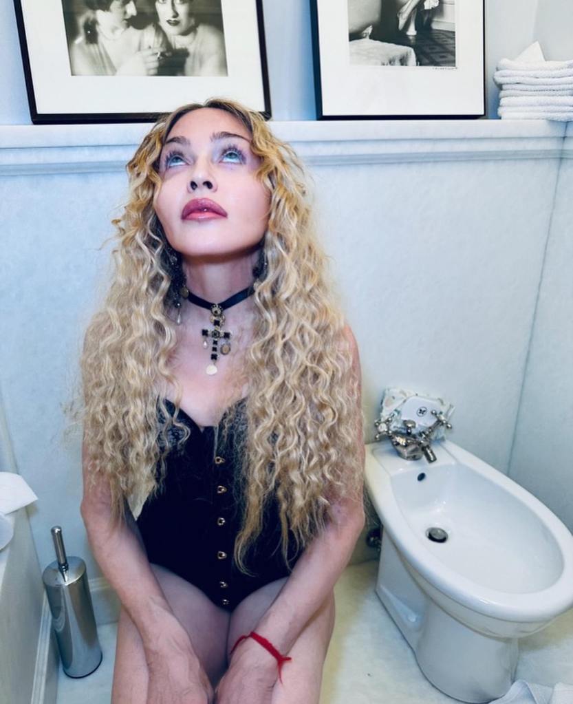 Photo of Madonna looking up at the ceiling. 