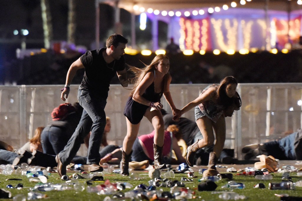 People run from the Route 91 Harvest country music festival after hearing the gun shots. 
