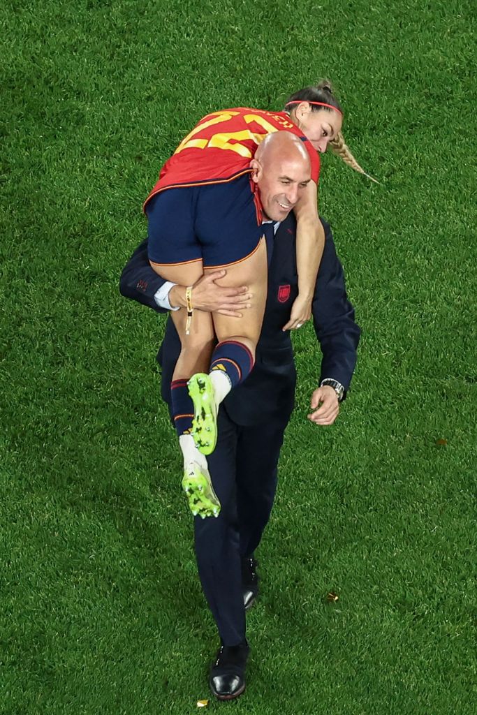 This picture taken on August 20, 2023 shows President of the Royal Spanish Football Federation Luis Rubiales carrying Spain's Athenea del Castillo Beivide on his shoulder as they celebrate winning the Australia and New Zealand 2023 Women's World Cup final football match between Spain and England