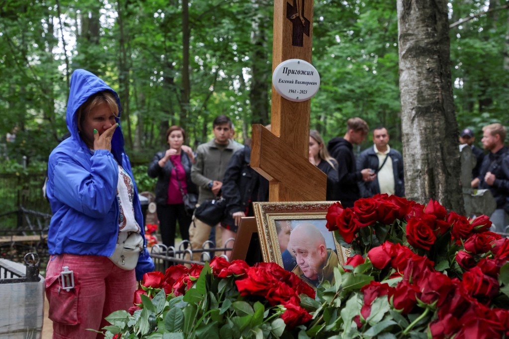 People gather near the grave of Russian mercenary chief Yevgeny Prigozhin at the Porokhovskoye cemetery in Saint Petersburg, Russia, August 30, 2023. 