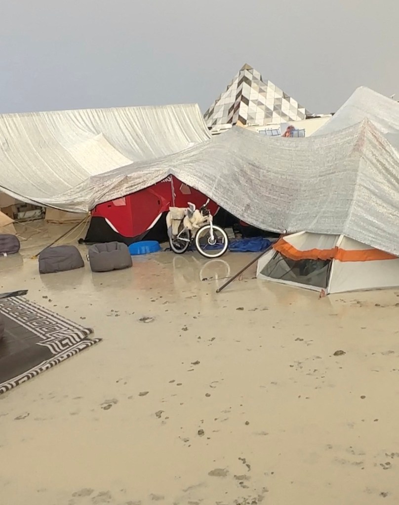 Tents are seen covered to protect them from the rain as the mud covers the ground at the site of the Burning Man festival in Black Rock, Nevada, U.S., September 1, 2023, in this screen grab obtained from a social media video. 
