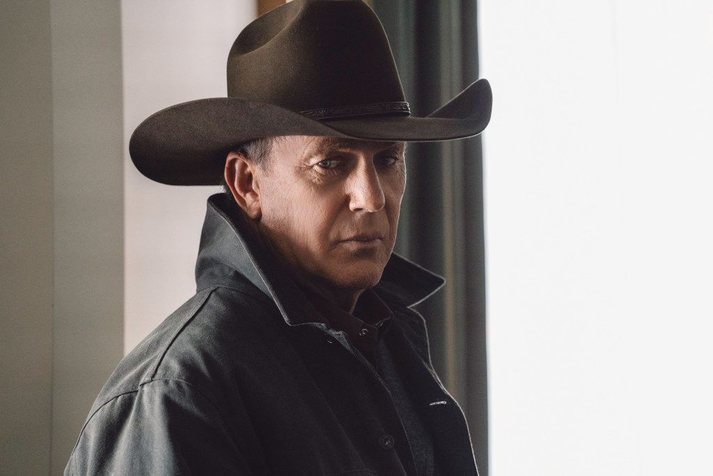 Kevin Costner in a cowboy hat looking serious. 