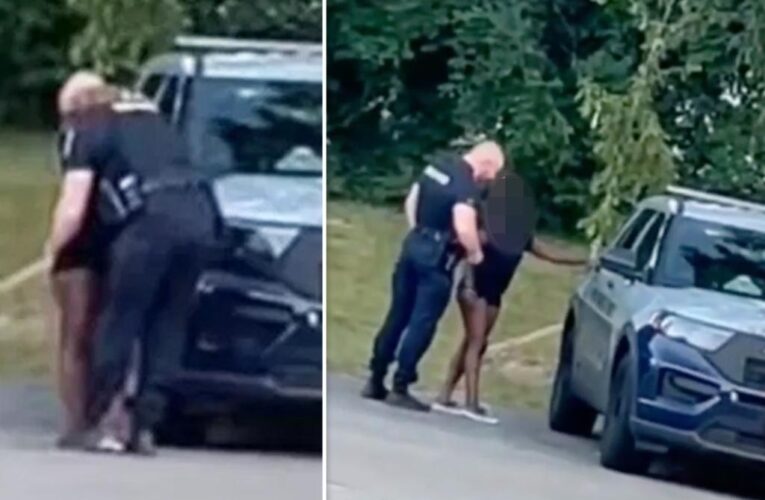 Maryland cop caught kissing scantily clad woman before climbing into back of squad car