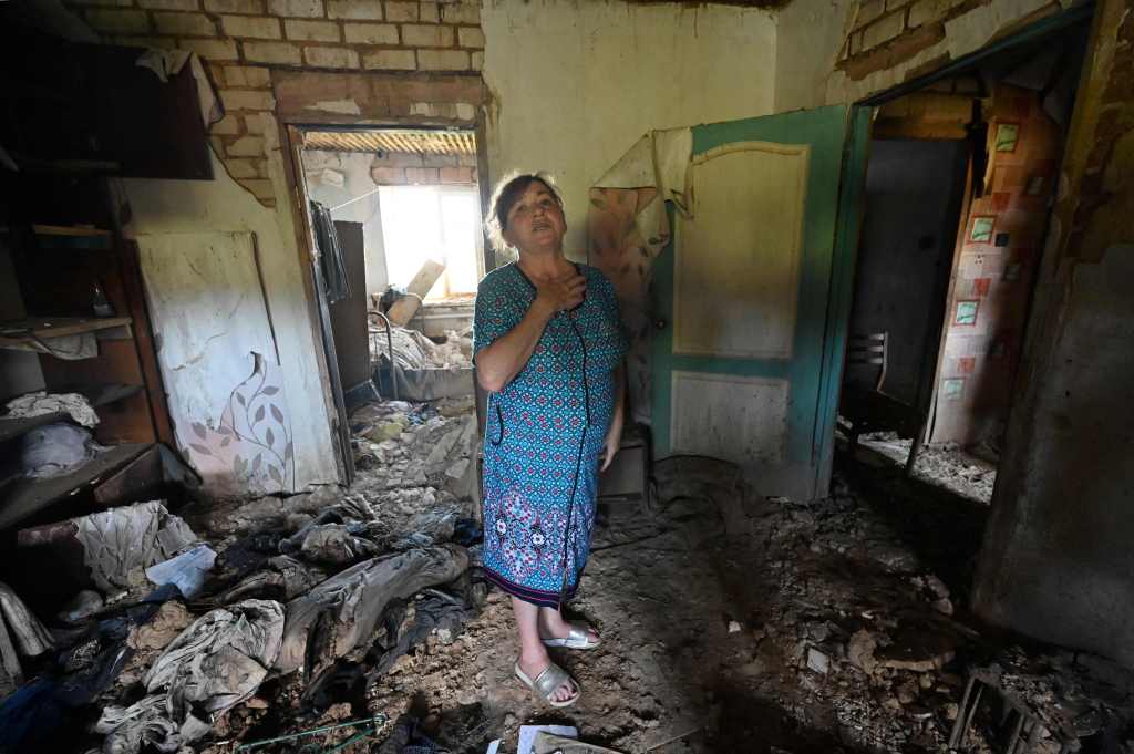Valentyna Hleha, 60, stands in a room of her house, partially destroyed during the hostilities in Kamianka, Kharkiv region, on September 5, 2023.