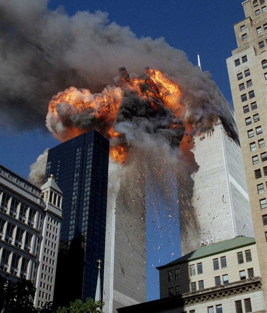 Smoke, flames and debris erupts from one of the World Trade Center 
