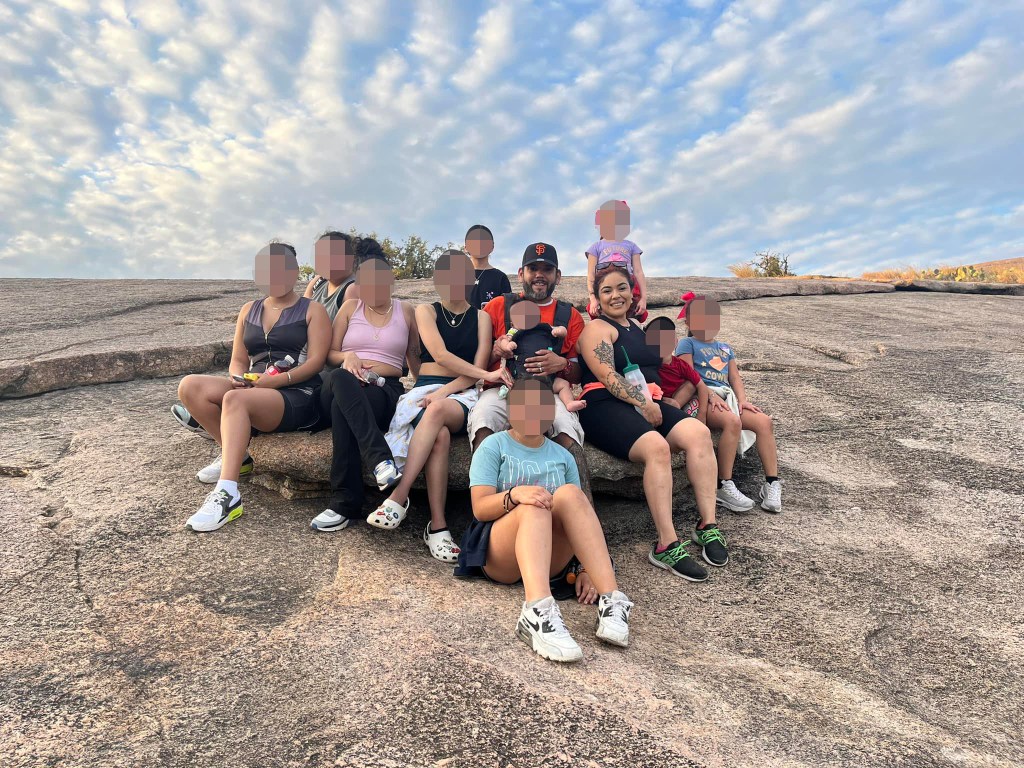 The Zunigas are pictured on a rock with their family.