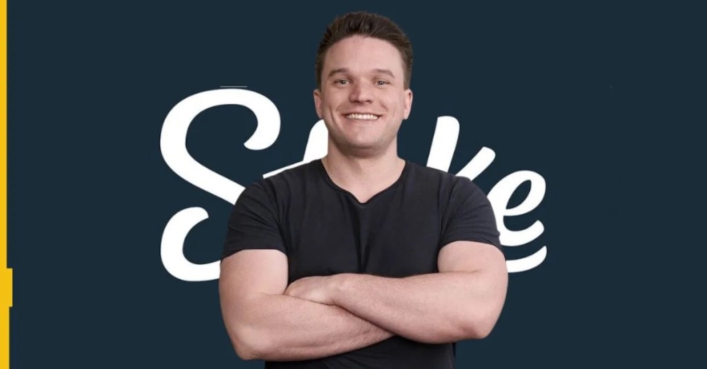 Edward Craven is pictured with his arms folded in front of the Stake.com logo.