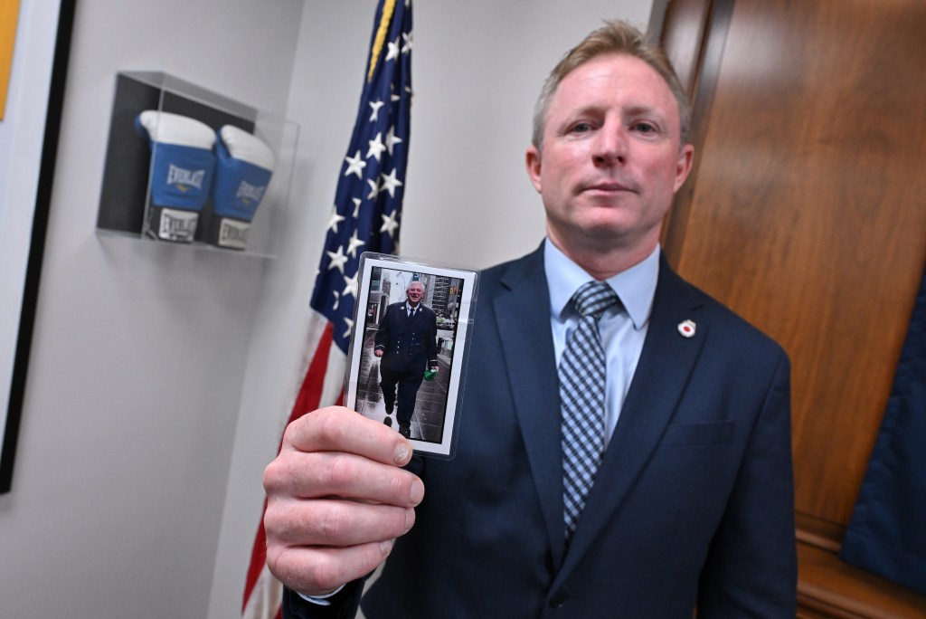 FDNY Uniformed Fire Officers Association President James Brosi holds photo of his beloved father Joseph Brosi who died of 9/11 related illnesses battling lung and bladder cancer