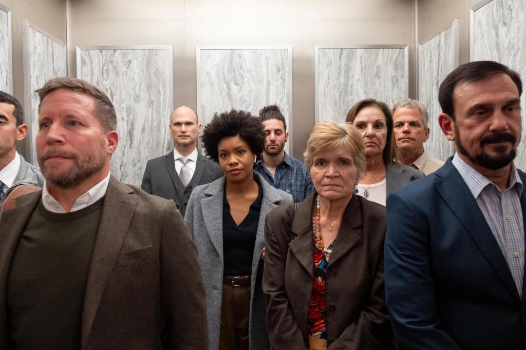 Nella (Sinclair Daniel) stands in the middle of a bunch of white people in an elevator. 