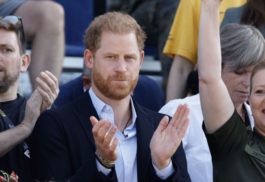 Photo of Prince Harry clapping. 