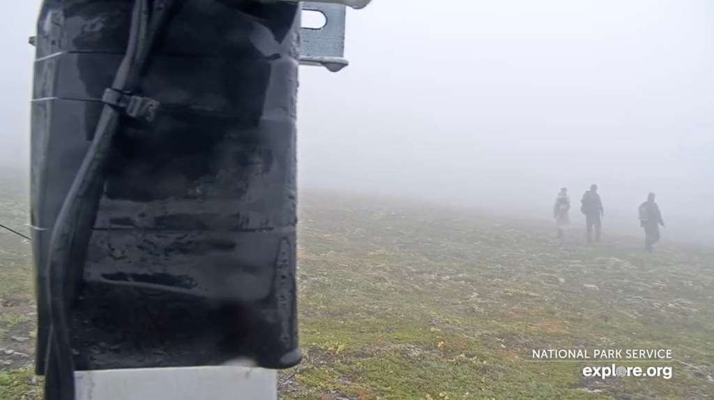 Rescuers seen walking through dense fog on Dumpling Mountain 