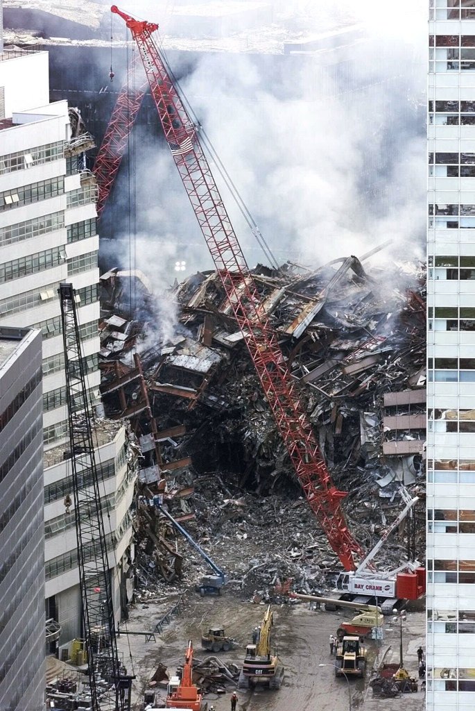 In this Sept. 18, 2001 file photo, a red crane looms over the smoldering wreckage of World Trade Center Building 7 in New York.