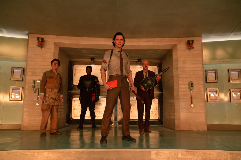 Ke Huy Quan as O.B., Wunmi Mosaku as Hunter B-15, Tom Hiddleston as Loki, and Owen Wilson as Mobius in "Loki" standing in a doorway. 