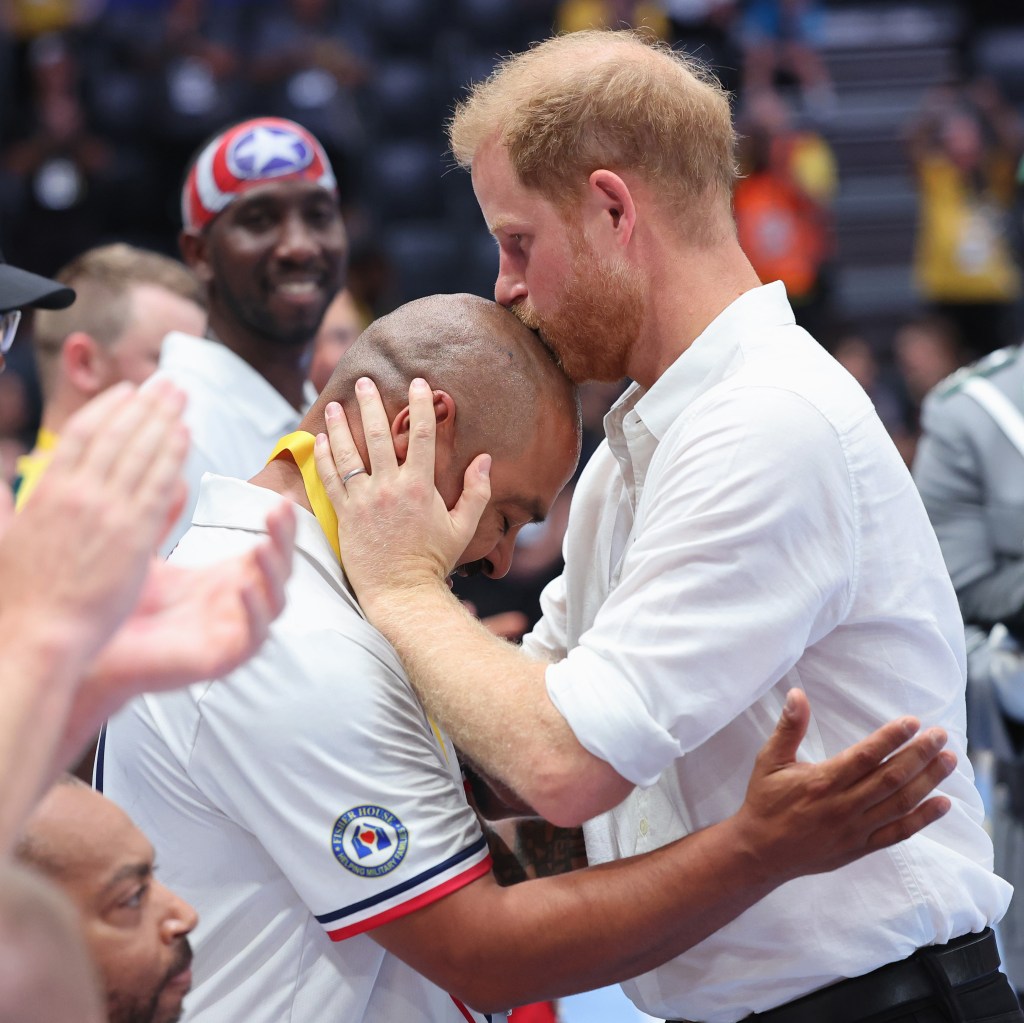 Photo of Prince Harry kissing someone's head. 