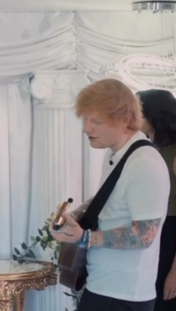 Ed Sheeran sings and strums a guitar in a wedding chapel. 