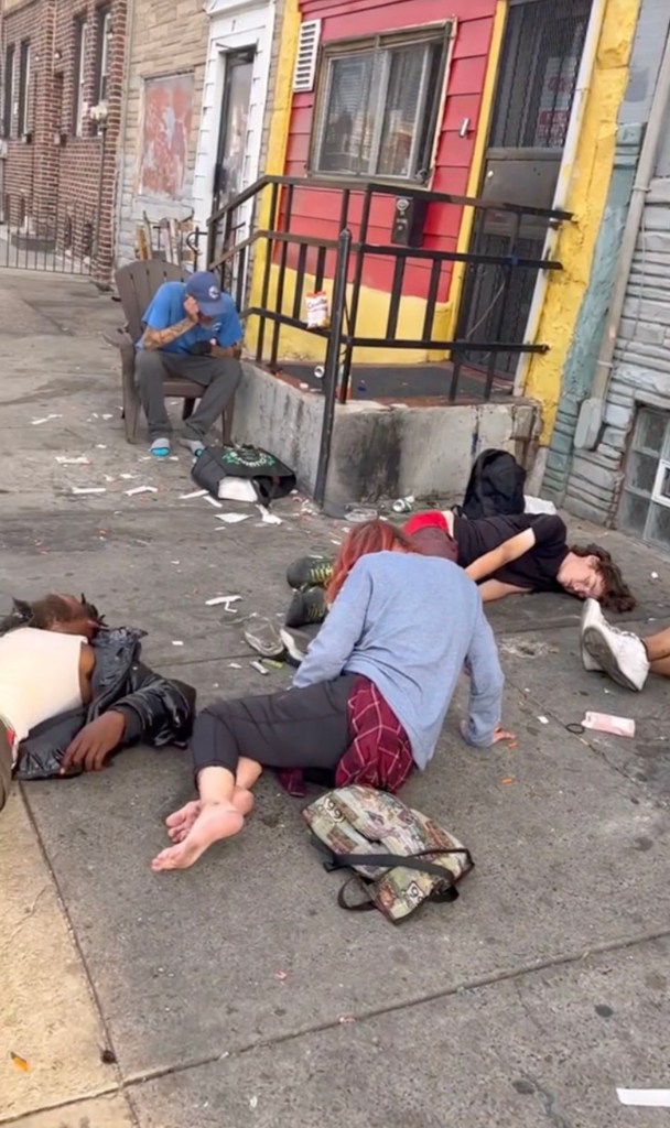 Drug addicts seen sprawled out on the sidewalk in Kensington 