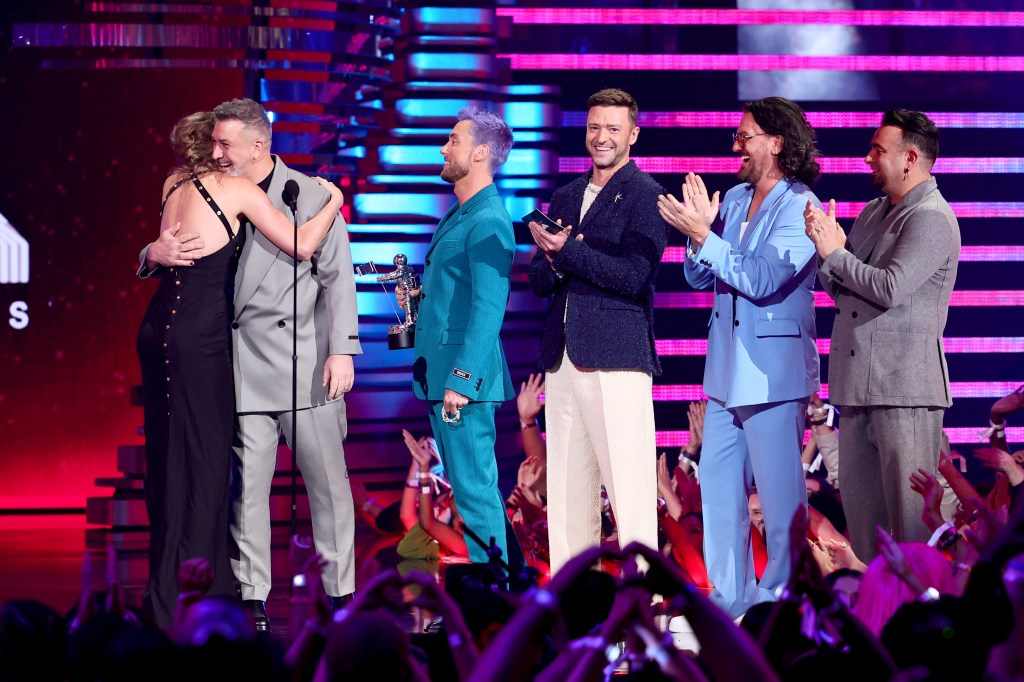 (L-R) Taylor Swift accepts the Best Pop award for "Anti-Hero" from Joey Fatone, Lance Bass, Justin Timberlake, JC Chasez, and Chris Kirkpatrick of NSYNC.