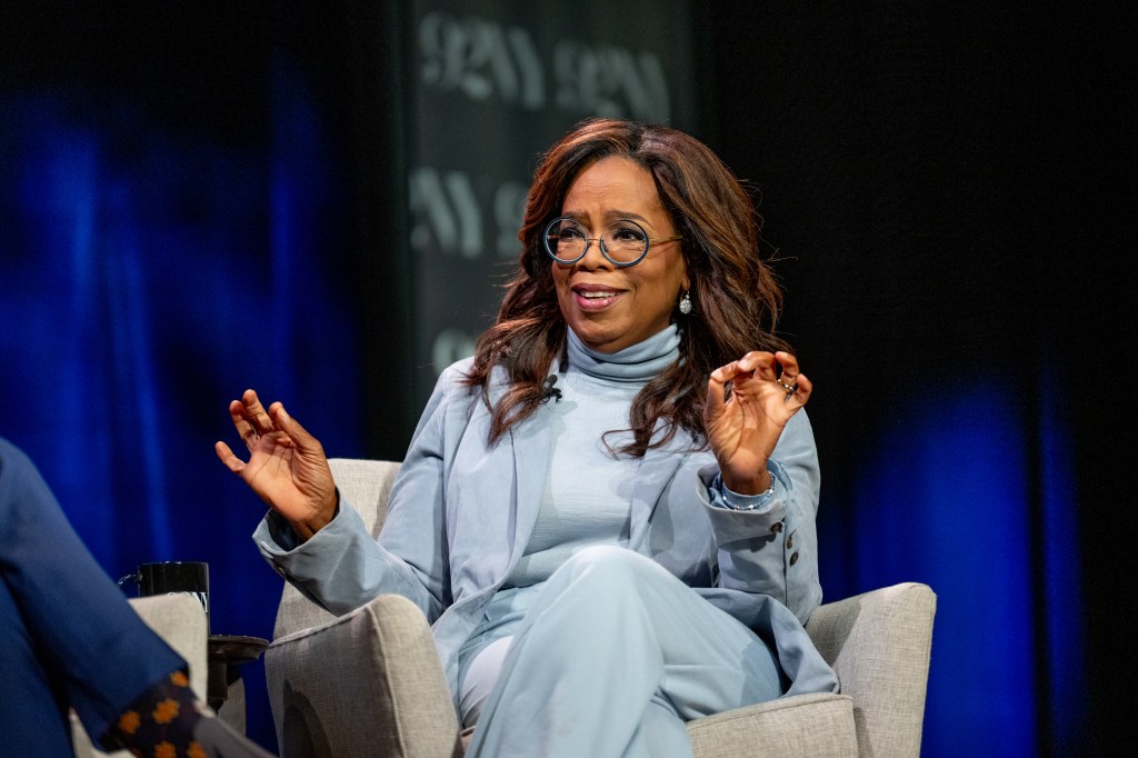 Oprah in a chair, talking. 