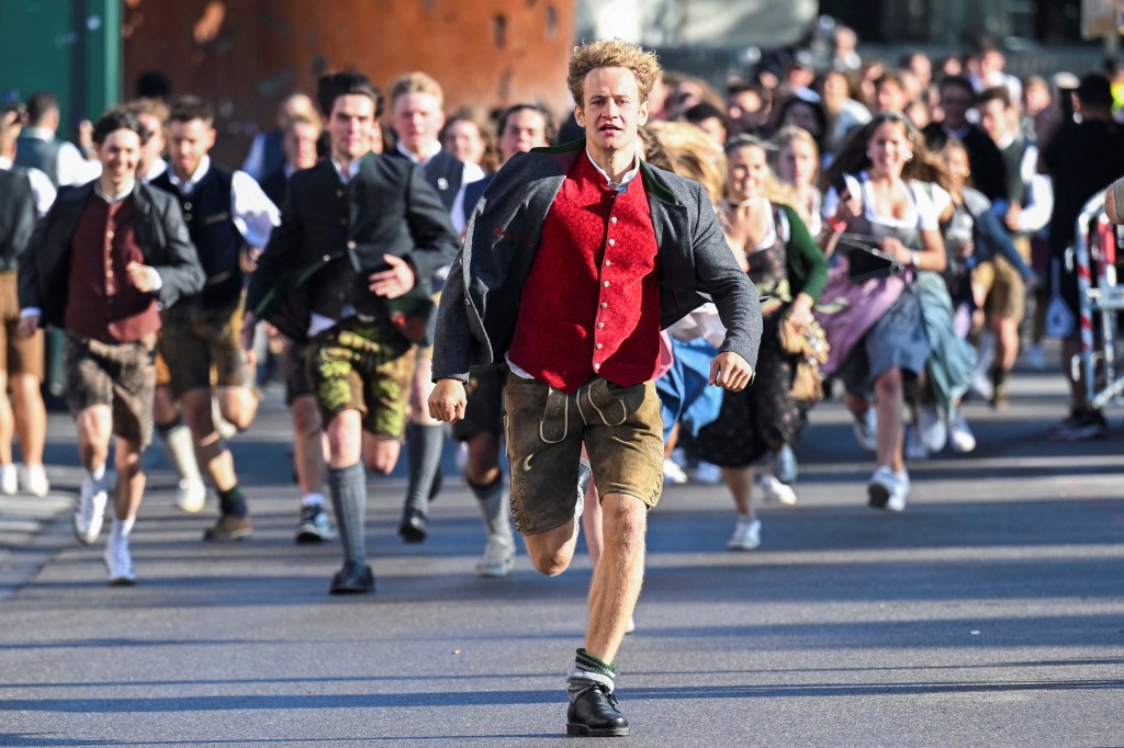 When the gates open, visitors race to get a good table inside the tents during Oktoberfest.