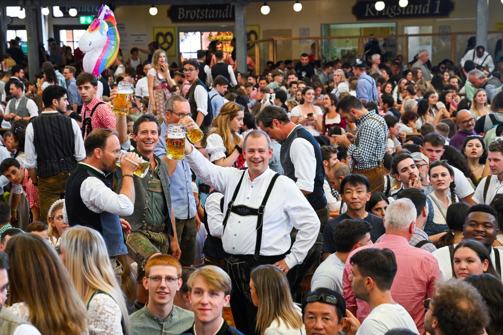 Revelers decked out in traditional lederhosen and dirndl dresses trooped to Munich’s festival grounds Saturday morning, filling the dozens of traditional tents in anticipation of getting their first 2-pint mug of beer.