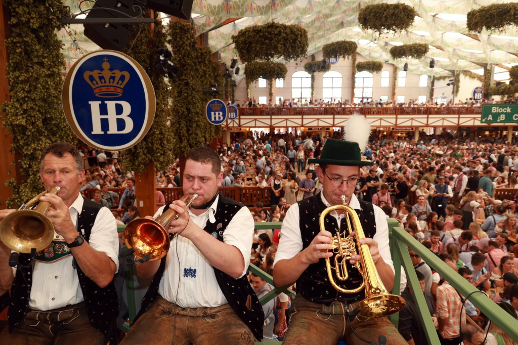 A band plays some songs while festival goers party down below.